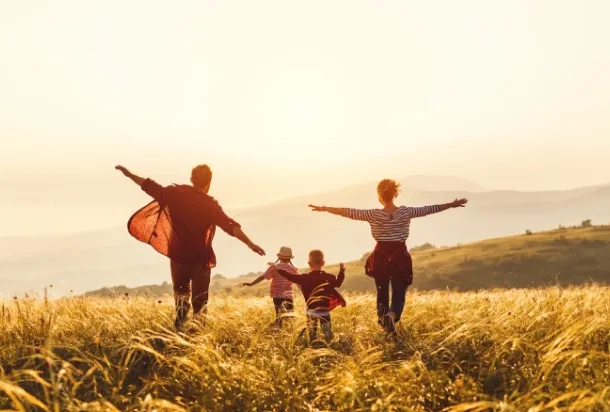 A family running to the sun in a magnificient landscape